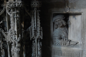 peeking out from under the pulpit stairs, thought to be a self-portrait of the sculptor